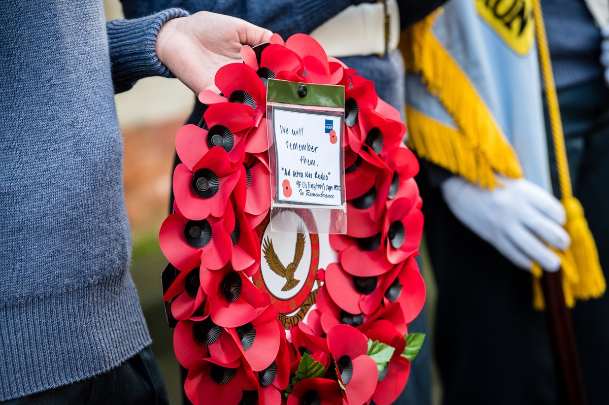 Hand holding a poppy wreath. Photo from 2019's Remembrance Day service at Islington Memorial Green