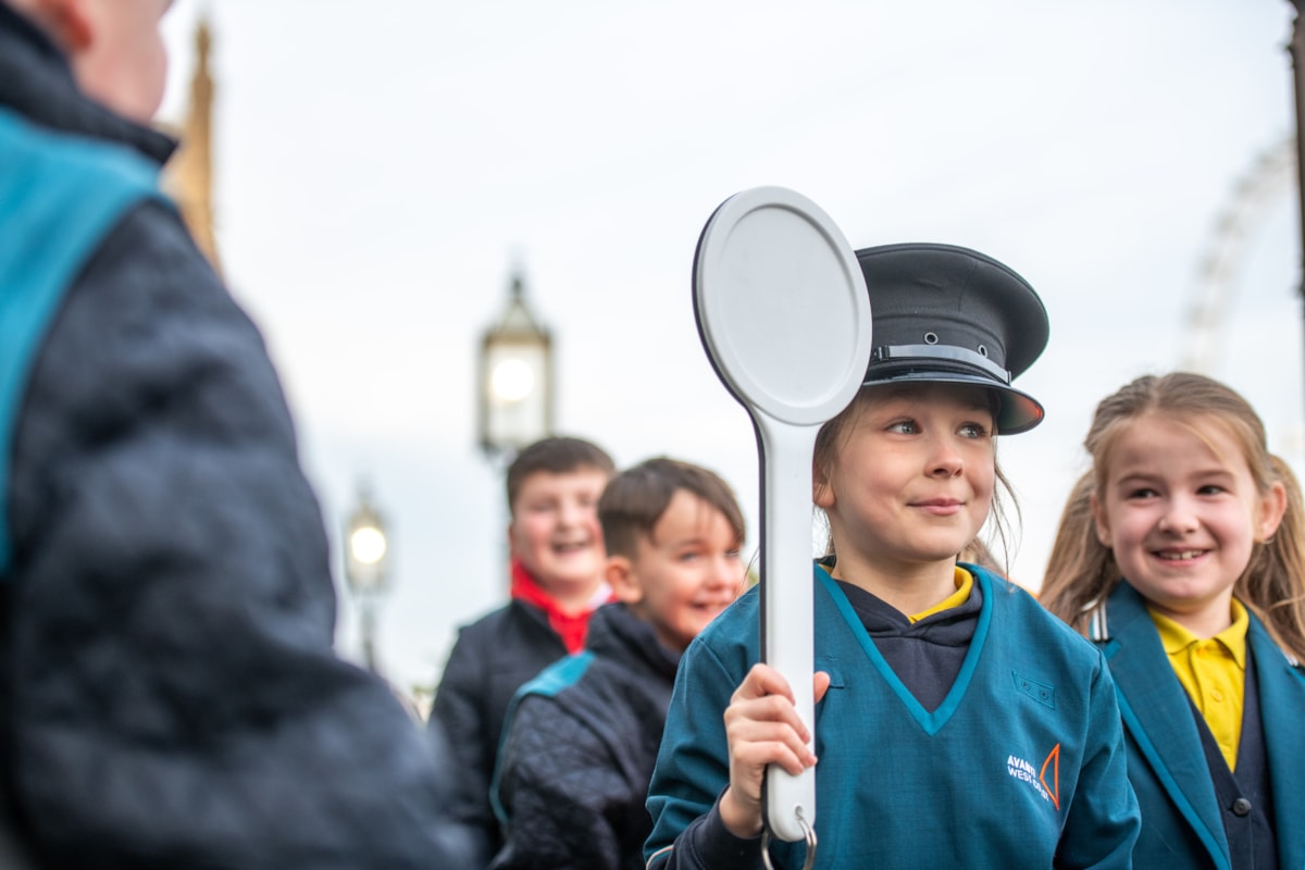 School pupils dress up in railway uniform at Avanti West Coast's celebration event in Parliament to mark the completion of its Feel Good Field Trips initiative.