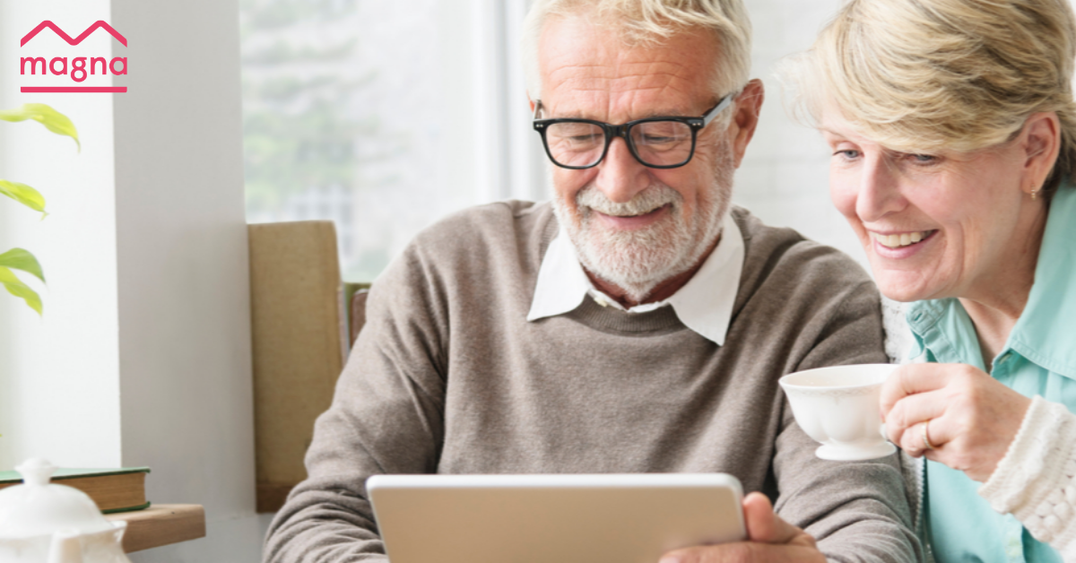 older couple on laptop with Magna logo (1)