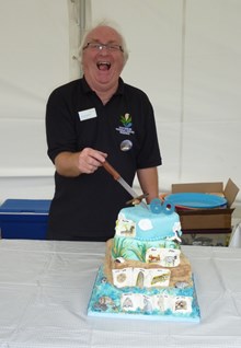 Tentsmuir reserve manager cuts 60th anniversary cake: Reserve manager Tom cuts Tentsmuir's 60th birthday cake. Please credit Scottish Natural Heritage.