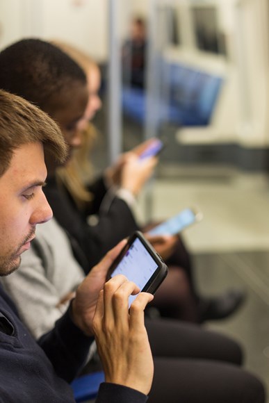 TfL Image - People using smartphones on the Jubilee line