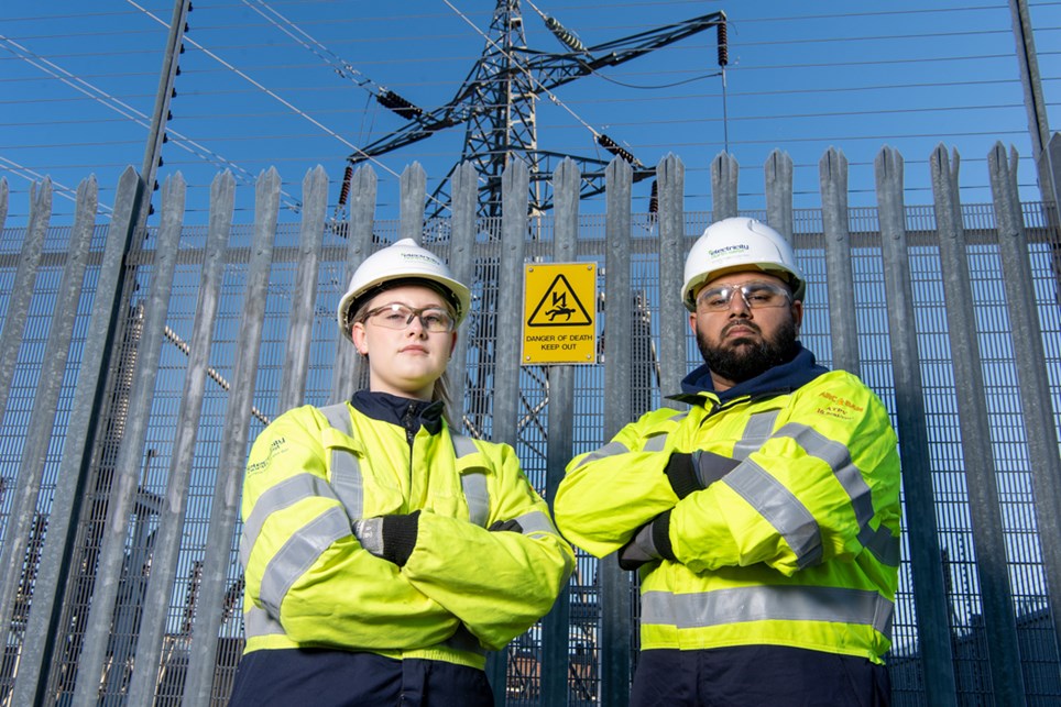 Electricity North West engineers with a danger of death sign