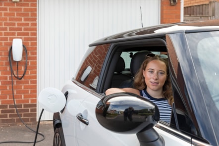 E.ON Next customer Abi, is pictured with her EV which is charging on her drive at home.