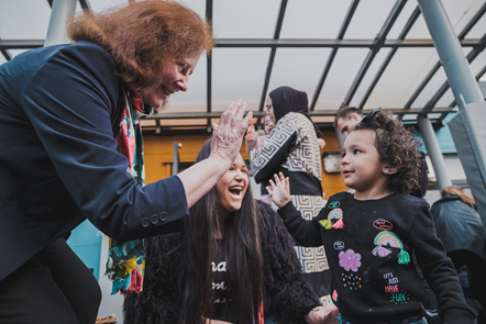 Julie Morgan high-fives a child for children's rights.