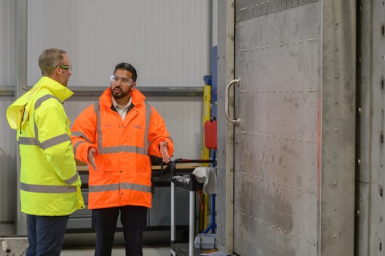 20260412 - Booth Industries MD, Mike Jenkinson (in yellow), and HS2 Ltd Head of Rail Systems Delivery, Qasir Raza at the cross-passage door factory in Bolton-3