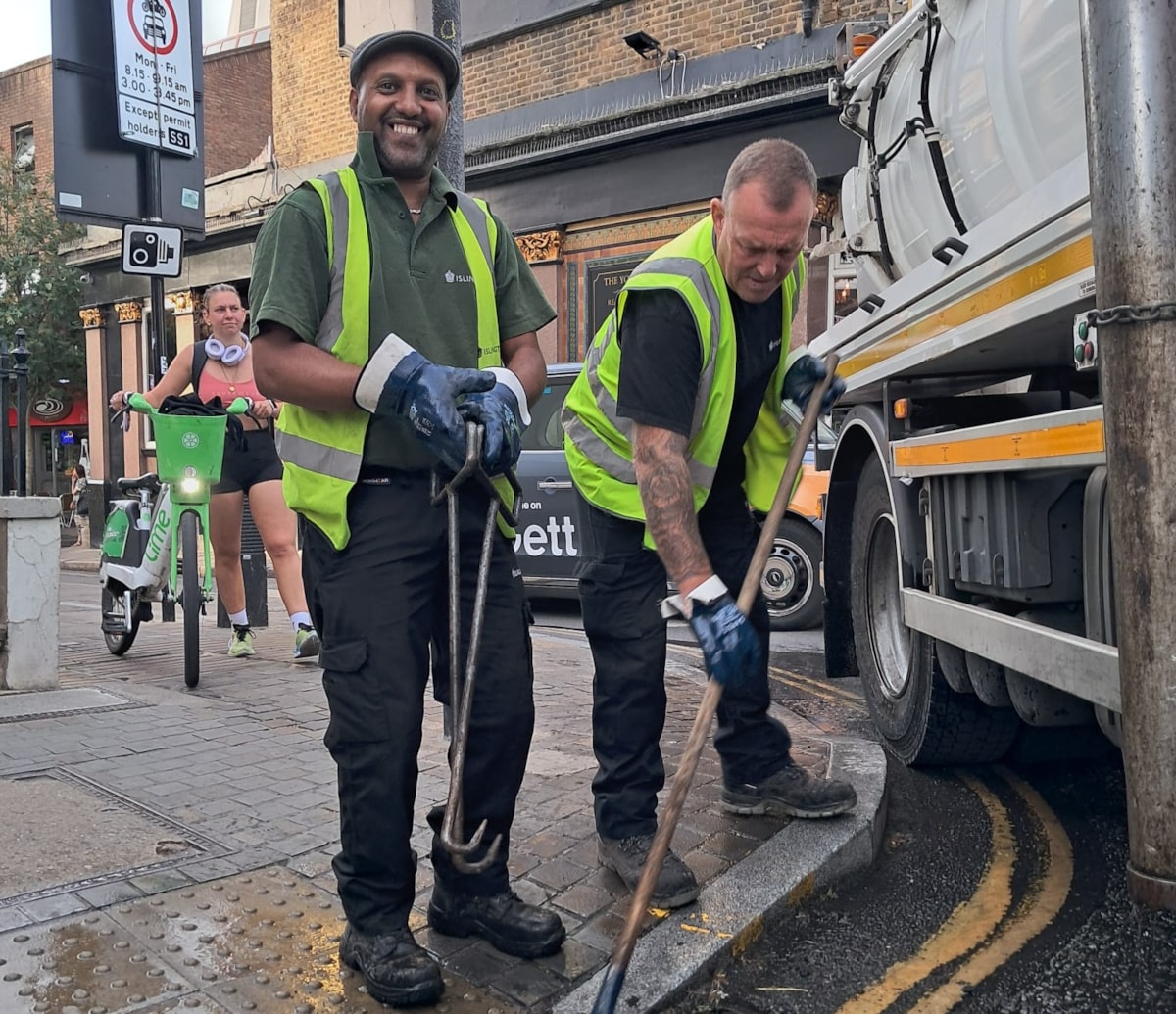 Street Cleaning Operatives Patrick Todd and Saadedin Suleiman clearing the street drainage in Angel