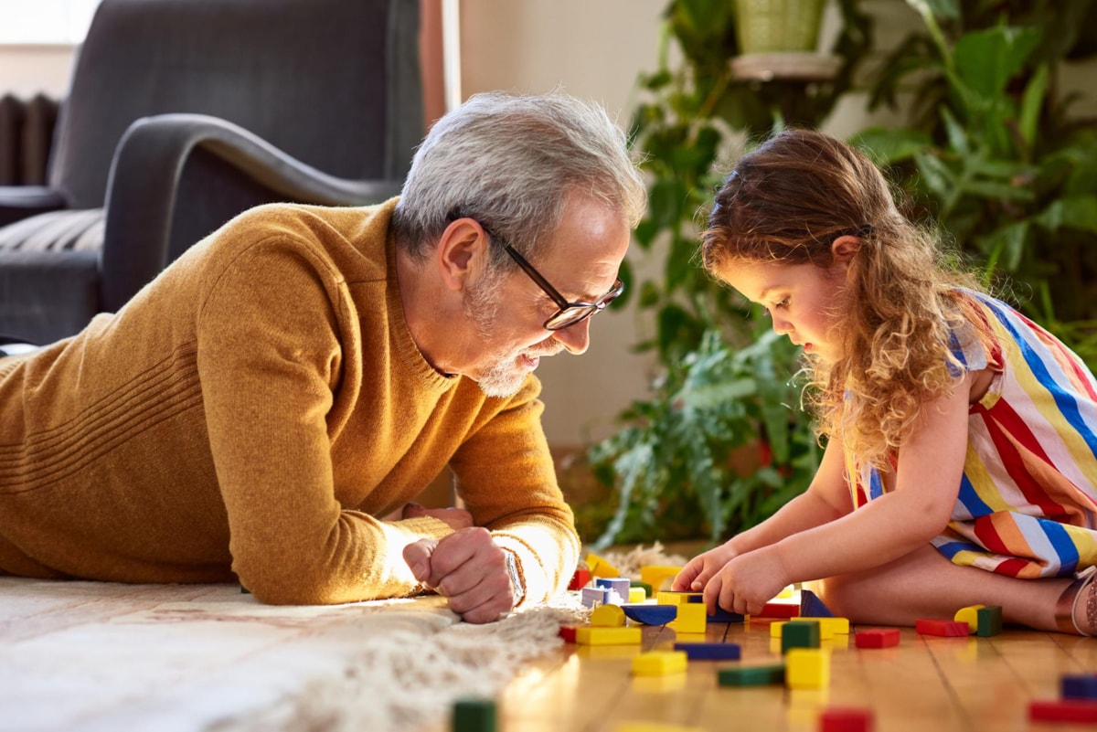 Grandfather and granddaughter playing