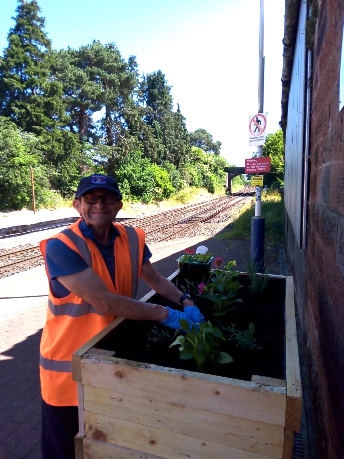 This image shows a volunteer at Dalston station