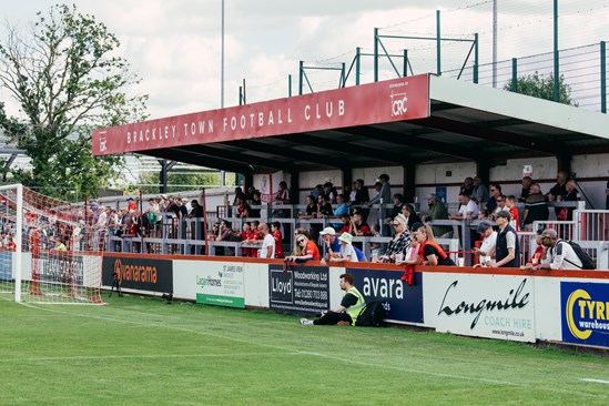 Brackley Town FC clubhouse rebuilt thanks to £75k HS2 grant: Crowd in the stands at Brackley FC