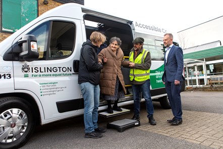 A resident is helped off an electric minibus by Cllr Champion and Keith Townsend, Islington's Corporate Director for Environment and Climate Change