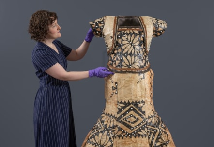 Curator Ali Clark prepares the barkcloth wedding dress for display. Photo © Neil Hanna (3)
