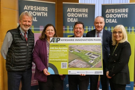 5 officials standing in front of Ayrshire Growth Deal posters, holding signage for new innovation park