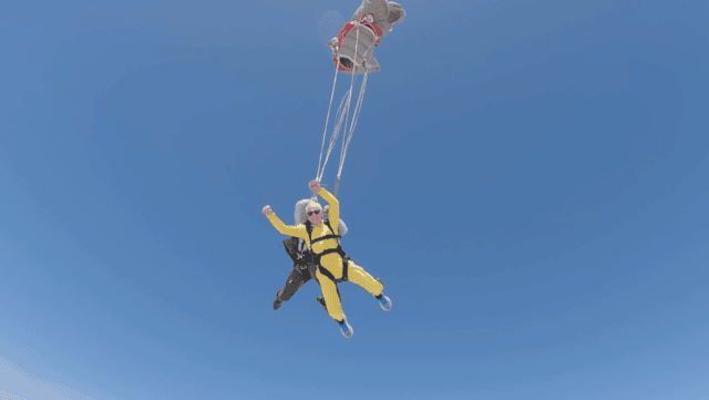 A final wave as his chute opens