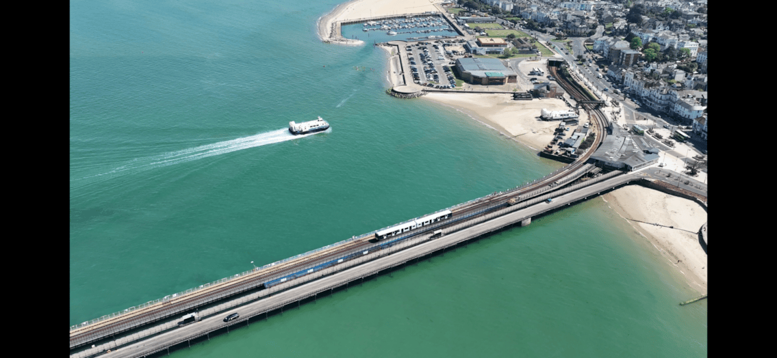 A Hovercraft and Island Line train make their way towards Ryde Esplanade