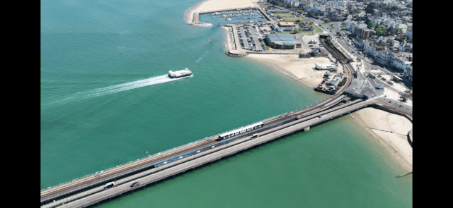 A Hovercraft and Island Line train make their way towards Ryde Esplanade
