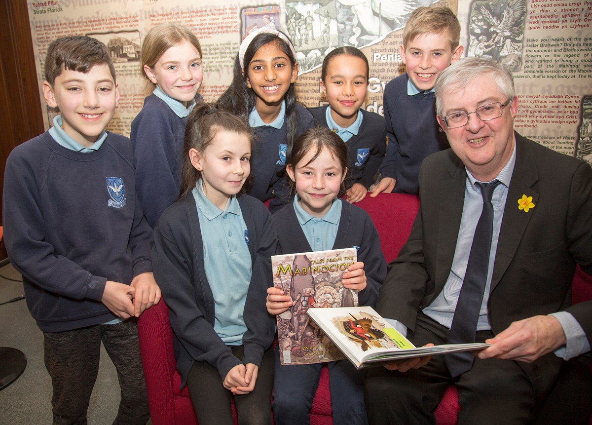 First Minister reads extracts of the Mabinogion to school pupils in the national Library of Wales ahead of World Book Day