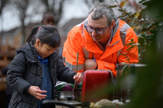 A Paget Primary School pupil and BBV volunteer in the mud kitchen in the new Forest School