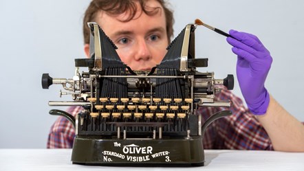 PhD student James Inglis takes a closer look at an Oliver Standard Visible Writer No. 3. Photo © Neil Hanna WEB