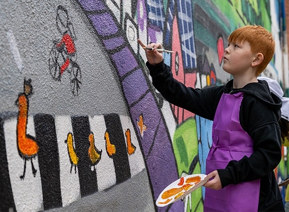 child-painting-mural-road