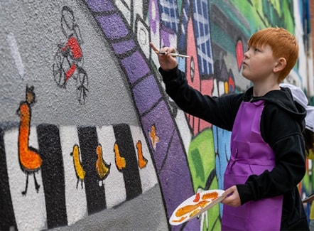 child-painting-mural-road