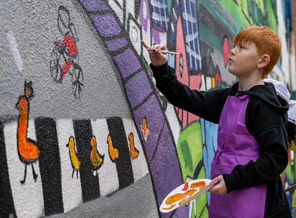 child-painting-mural-road