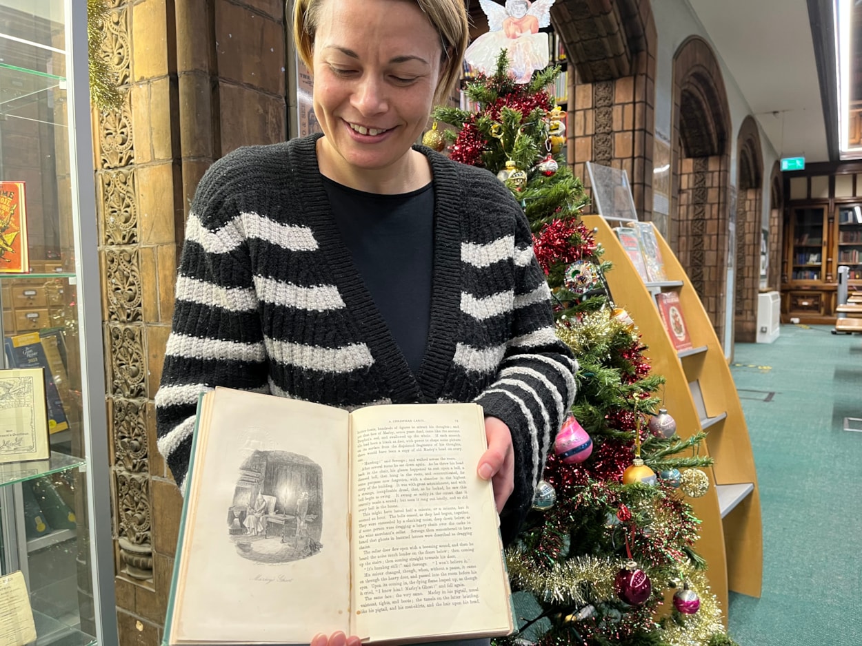 Library Christmas books: Library and digital assistant Anna Jones with a 19th Century edition of A Christmas Carol.
Dickens’ first run of 6,000 copies of A Christmas Carol sold out by Christmas Eve of 1843, with publishers returning to the press another eight times within the first six months of publication to meet demand.