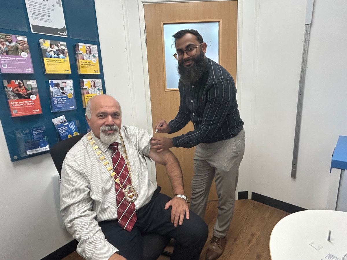 Deputy Mayor Councillor Mushtaq Hussain recives his vaccine at Well Pharmacy at The Northway from pharmacist Thanvir Choudhury