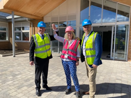 Cllr Steve Clark, headteacher Marie Hunter and Cllr Wayne Little at the entry to the new school site