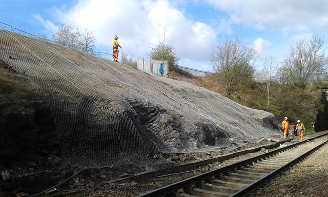 Services back on track as landslide recovery works completed: Lambhill landslip 1 - engineers installing rock netting
