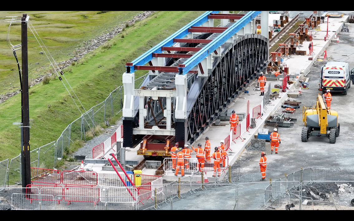 Engineers moving new span on mock railway Barmouth