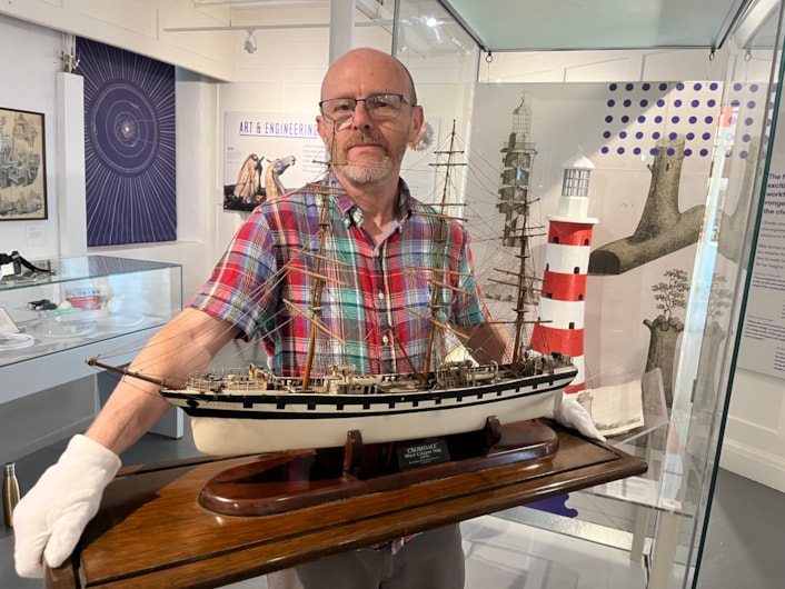 Model ships: Curator John McGoldrick with a replica of “cursed” wool clipper Cromdale, built in Glasgow in 1891.
After narrowly escaping disaster when her maiden voyage was hit by freak 300ft high icebergs, she later ran aground in thick fog, ploughing into cliffs off the coast of Cornwall, where her wreck is still visible today.
